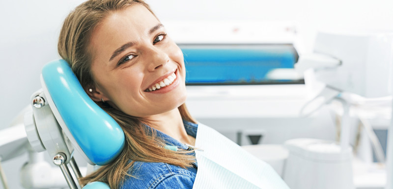a female patient smiling before her exam
