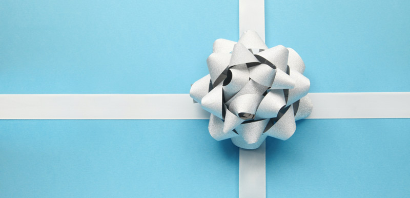 a blue gift wrapped present with a white bow